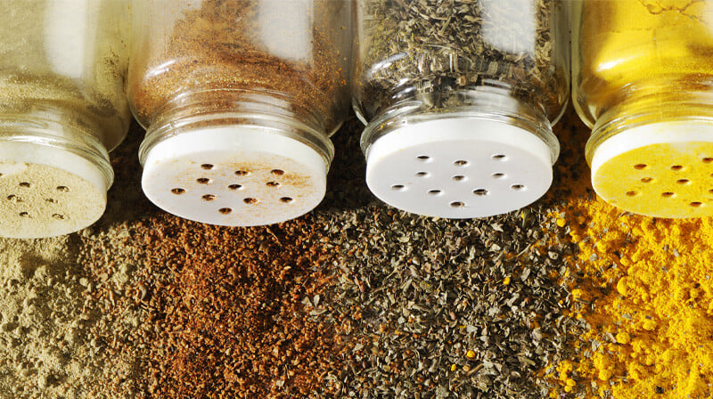 Bottle of spices with spices background